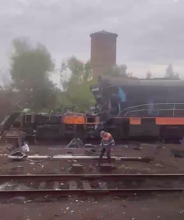 A rail worker is seen assessing the damage after a train was hit by a Russian missile near the Ukrainian border with Poland
