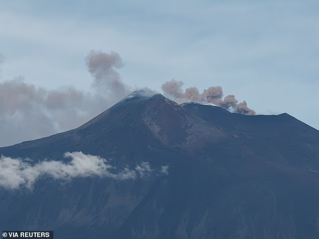 A drone view shows volcanic ash and fumes over the skyline during an eruption at Mount Etna on Monday