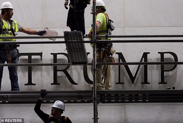 Workers prepare scaffolding ahead of removing lettering from the facade of the John F. Kennedy Memorial Center for the Performing Arts, following a federal judge's order to remove Trump's name from the institution