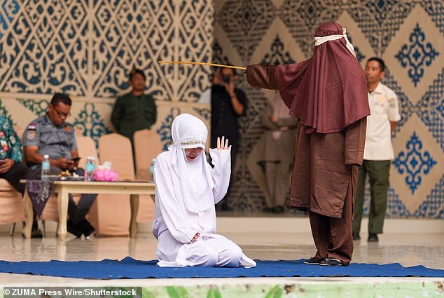 Lovers are flogged 100 times each for adultery with girlfriend begging for mercy then collapsing in pain during brutal Sharia caning in Indonesia