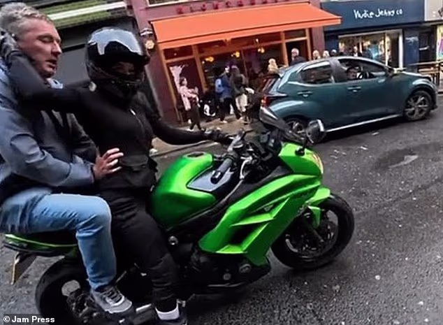 Moment 'inappropriate old man' jumps on primary school worker's motorbike and grabs her hips in front of his laughing pals