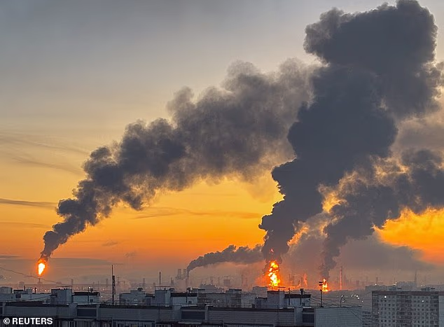 Plumes of smoke rise from fires (right) at an oil refinery on Sunday after what the Russians says was Ukraine's largest attack on Moscow