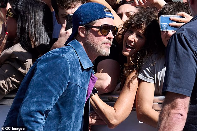 Brad Pitt was mobbed by fans as he arrived at the San Sebastian Film Festival in Spain on Sunday - just after friends revealed how his marriage to Angelina Jolie sent his life 'spiraling'