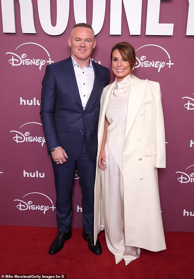 Coleen Rooney looked nothing short of sensational in a glamorous white satin outfit as she joined husband Wayne at their Disney+ premiere in London on Tuesday
