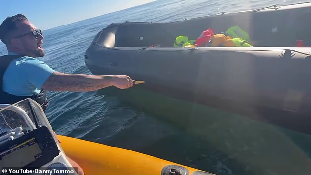 The anti-migrant activist - real name Daniel Thomas - brought his boat up alongside the dinghy after all the migrants on board had been picked up by the RNLI