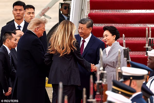President Donald Trump and First Lady Melania Trump greet China's President Xi Jinping and his wife Peng Liyuan upon their arrival at Joint Base Andrews on Wednesday