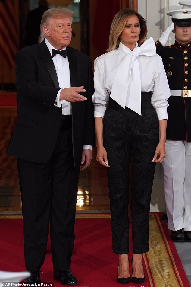 President Donald Trump and first lady Melania Trump wait to greet China's President Xi Jinping and his wife Peng Liyuan at the North Portico of the White House for a State Dinner