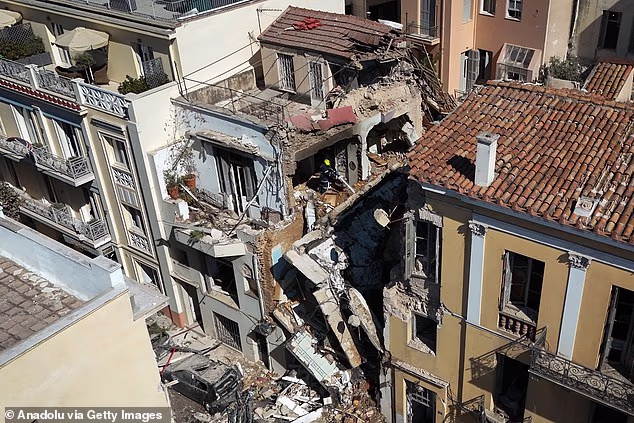 Firefighters operate following a blast that caused a building to collapse and injured two people in Athens, Greece on September 25, 2026
