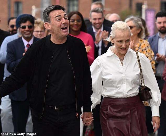 Andy Burnham pictured with his wife Marie-France van Heel in Liverpool on September 26. Labour descended into open warfare over immigration and the economy on Saturday night