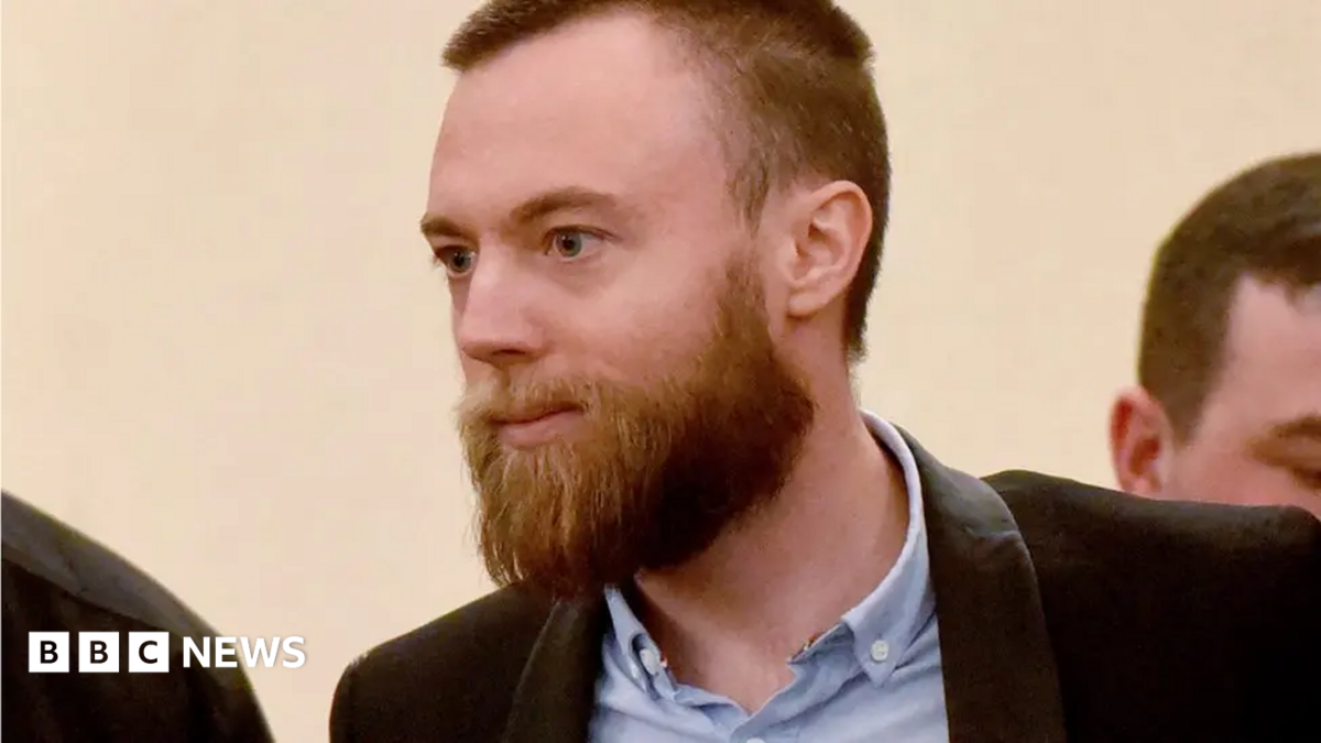 Jack Shepherd in court. He wears a shirt and jacket and has a beard