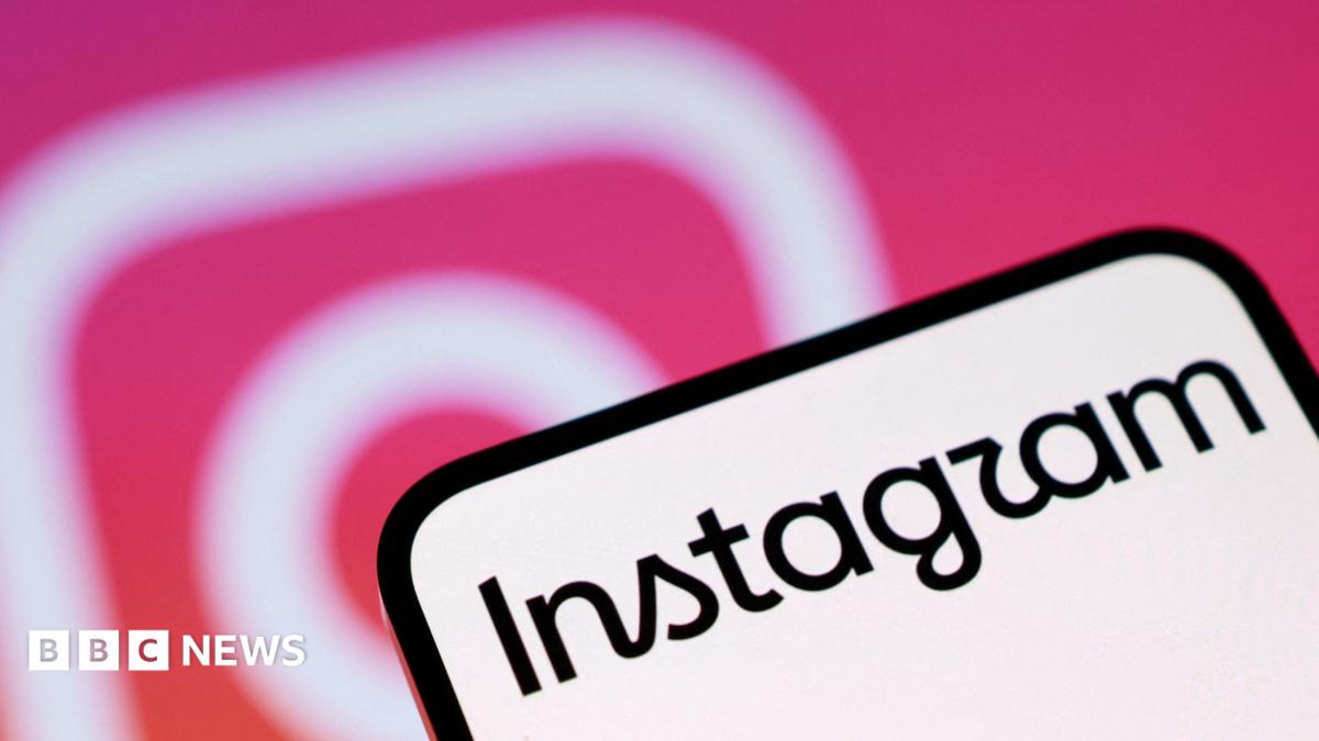 A phone screen with Instagram written on it. In the background is the pink and white Instagram camera logo