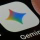 A close-up shot of the Gemini application on a black screen. The icon is a white square with a four-point star in Google's colours, under which the word 'Gemini' is printed.