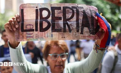 A woman holds a sign during a demonstration calling for the return of opposition leader Maria Corina Machado and free elections in Venezuela, in Caracas.