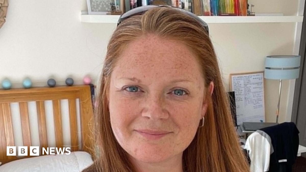 A woman with ginger hair looking at the camera.