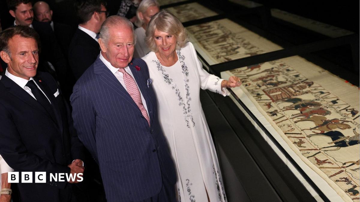 King Charles, President Macron and Queen Camilla looking at the Bayeux Tapestry