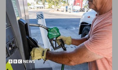 A driver returns a fuel nozzle after refueling a tractor trailer with diesel fuel at a Chevron truck stop in Tracy, California.