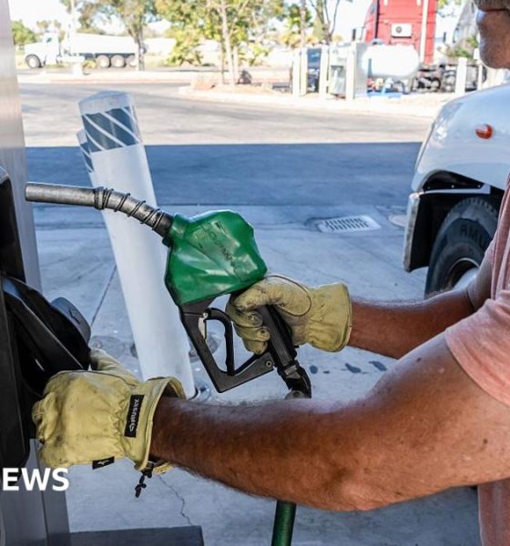 A driver returns a fuel nozzle after refueling a tractor trailer with diesel fuel at a Chevron truck stop in Tracy, California.