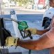 A driver returns a fuel nozzle after refueling a tractor trailer with diesel fuel at a Chevron truck stop in Tracy, California.