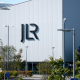 A large white building with the letters JLR in black writing on the side