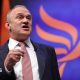 Ed Davey delivers speech to Lib Dem conference in suit and tie