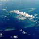 A bird's eye view of the Chagos Islands – officially known as the British Indian Ocean Territory – in the Indian Ocean, with white clouds in the sky.