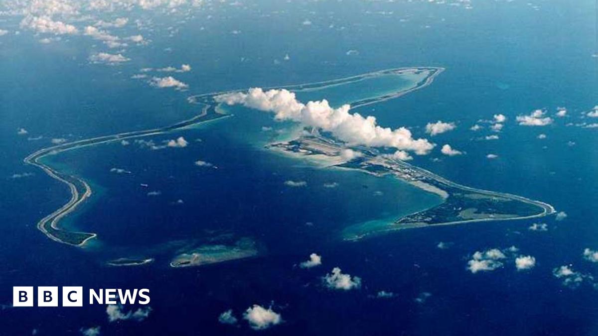A bird's eye view of the Chagos Islands – officially known as the British Indian Ocean Territory – in the Indian Ocean, with white clouds in the sky.