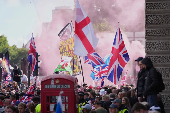 People demonstrate during the Tommy Robinson-led Unite the Kingdom march and rally, in London, Saturday Sept. 13, 2025.