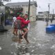 People walk in flooded streets in Surf City, New Jersey, on 26 September 2026