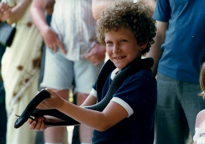 The author age 7. "I loved snakes and I was fearless," they write.