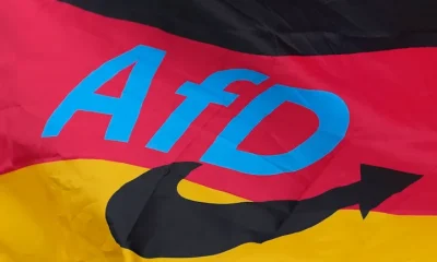 The logo of the "Alternative for Germany" (AfD) party is fixed on a German national flag for the state elections in Saxony-Anhalt during an election campaign event in Magdeburg, Germany, Friday, Sept. 4, 2026.