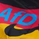 The logo of the "Alternative for Germany" (AfD) party is fixed on a German national flag for the state elections in Saxony-Anhalt during an election campaign event in Magdeburg, Germany, Friday, Sept. 4, 2026.