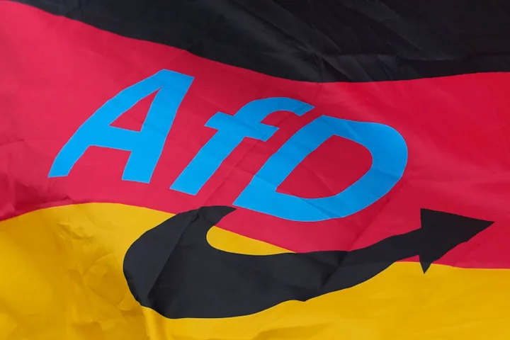 The logo of the "Alternative for Germany" (AfD) party is fixed on a German national flag for the state elections in Saxony-Anhalt during an election campaign event in Magdeburg, Germany, Friday, Sept. 4, 2026.
