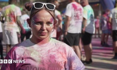 A female university student covered in pain. She is participating in a fun run event.