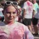 A female university student covered in pain. She is participating in a fun run event.