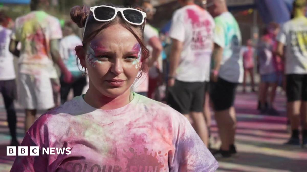 A female university student covered in pain. She is participating in a fun run event.