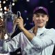 Elena Rybakina holds up the 2025 WTA Finals trophy