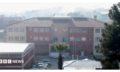 A photo of the school where the attack took place, taken in 2022 - it's a three story building that looks fairly modern but unremarkable - it has a mix of cream and red colouring and is seen from a middistance