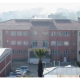 A photo of the school where the attack took place, taken in 2022 - it's a three story building that looks fairly modern but unremarkable - it has a mix of cream and red colouring and is seen from a middistance