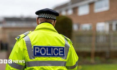 A stock image of a police officer with his back to the camera