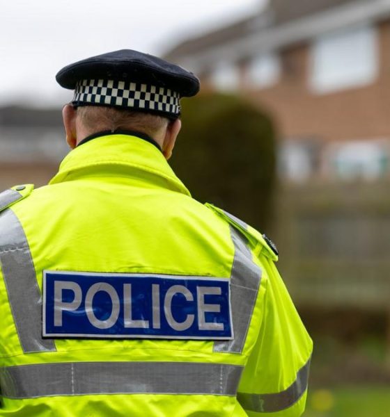 A stock image of a police officer with his back to the camera