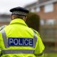 A stock image of a police officer with his back to the camera