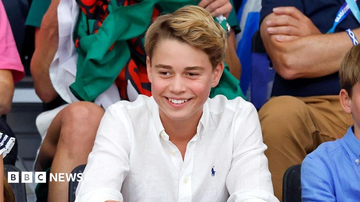 Prince George at the Commonwealth Games in August 2026. He is wearing a white shirt and smiling.