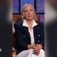 Deborah Meaden has blonde hair, She is wearing a white shirt and trousers with a dark blue jacket.