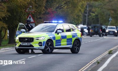 A police car is pictured on a road