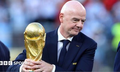 Gianni Infantino holding the World Cup trophy
