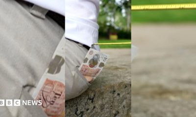 A £10 note sticking out of someone's back pocket with a tape measure attempting to steal it.