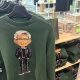 Green Nvidia jumpers with an image of the company's boss Jensen Huang on the front, hanging up on a store