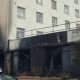 The front of a hotel damaged by fire.