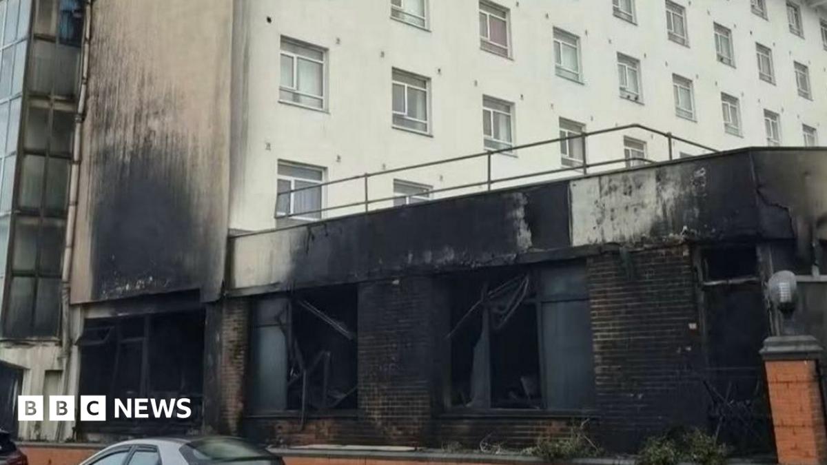 The front of a hotel damaged by fire.