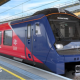 A red and blue train is parked up at station